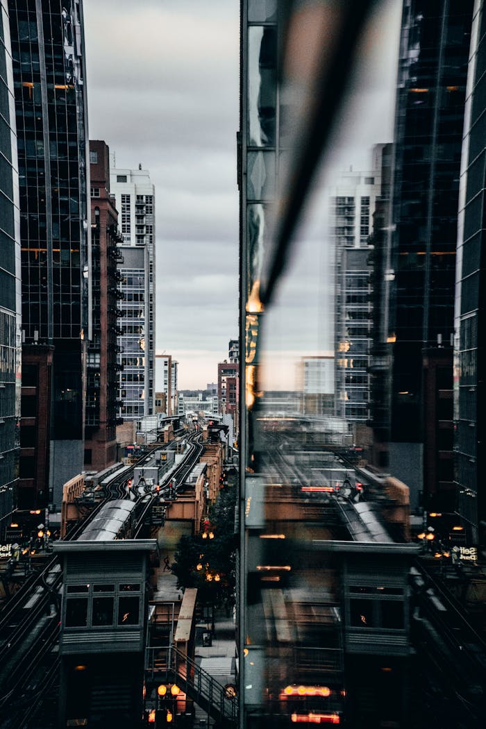 about-01 View of Chicago's elevated train with city reflections at twilight.